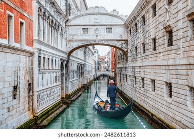 Gondolas floating on canal towards Bridge of Sighs (Ponte dei Sospiri). Venice, Italy