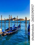 Gondolas sway gently before the misty silhouette of San Giorgio Maggiore, Venice Italy