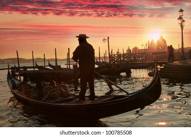 Gondolier against beautiful sunset in Venice, Italy