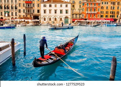 Gondolier Carries Tourists On Gondola Grand Canal Of Venice, Italy.