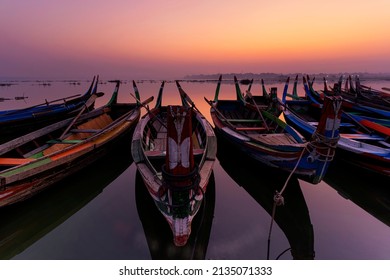 Gondora boats. A fisherman wooden boat parked under the U-Bein Bridge At sunrise. Amarapura, Mandalay, Mynmar. - Shutterstock ID 2135071333