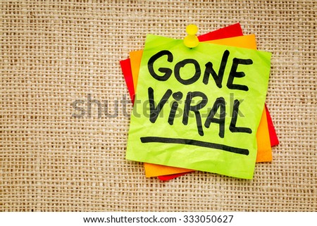 Gone viral - handwriting on a sticky note against burlap canvas