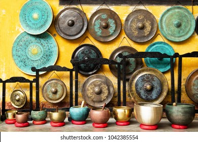 Gongs and singing bowls - traditional Asian musical instruments on a street market. Hoi An, Vietnam.