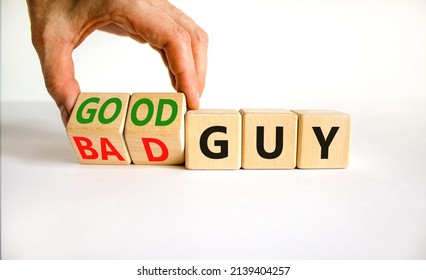 Good or bad guy symbol. Businessman turns cubes and changes concept words Bad guy to Good guy. Beautiful white background. Business psychological good or bad guy concept. Copy space.