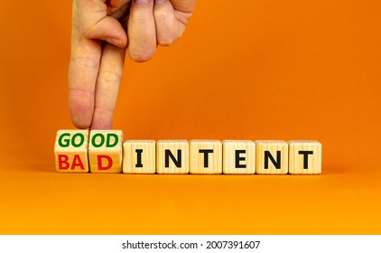 Good or bad intent symbol. Businessman turns wooden cubes and changes words 'bad intent' to 'good intent'. Beautiful orange table, orange background. Business, bad or good intent concept. Copy space. - Shutterstock ID 2007391607