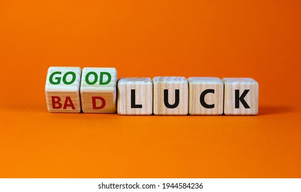 Good or bad luck symbol. Turned wooden cubes and changed words 'bad luck' to 'good luck'. Beautiful orange background, copy space. Business and good or bad luck concept.