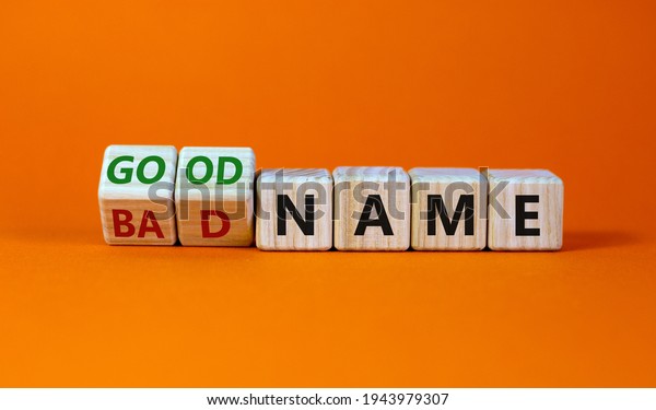 Good or bad name\
symbol. Turned wooden cubes and changed words \'bad name\' to \'good\
name\'. Beautiful orange background, copy space. Business and good\
or bad name concept.