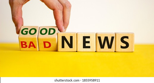 Good or bad news concept. Hand flips cubes and changes the words 'bad news' to 'good news'. Beautiful yellow table, white background. Business concept. Copy space.
