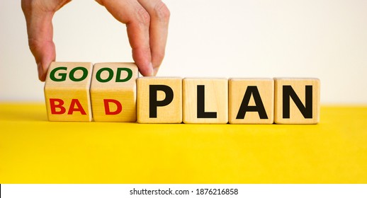 Good a bad plan symbol. Male hand flips wooden cubes and changes words 'bad plan' to 'good plan'. Beautiful yellow table, white background, copy space. Business and good plan concept.