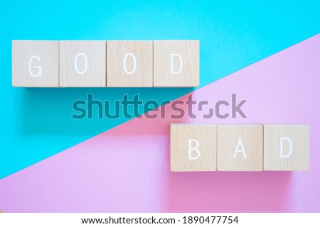 Good and Bad; Seven wooden blocks with GOOD BAD text of concept.