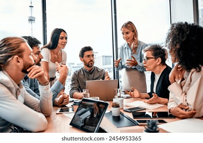 Good business idea. Inspired coworkers generating proposition for growing department's result. Enthusiastic women and men discussing project at meeting with excited facial expression. - Powered by Shutterstock