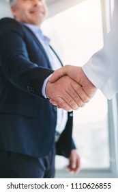 Good Collaboration. Joyful Affluent Businessman Smiling And Shaking Hands With The Doctor