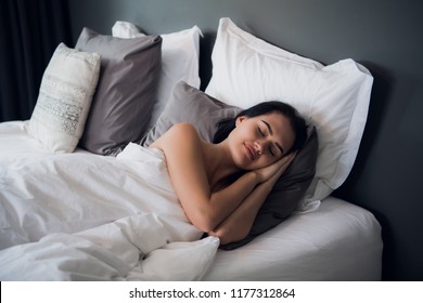 Good dreams make your day better. Attractive young woman sleeping joyfully - Shutterstock ID 1177312864