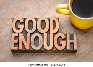 Good enough - word abstract in vintage letterpress wood type with a cup of coffee - Shutterstock ID 1130223548