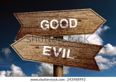Good Or Evil concept road sign with blue sky background.