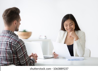 Good First Impression At Job Interview Concept, Smiling Asian Woman Hr Reading Resume Of Job Seeker, Recruiter Employer Holds Cv Of Vacancy Applicant At Hiring Negotiations, Employment And Recruiting