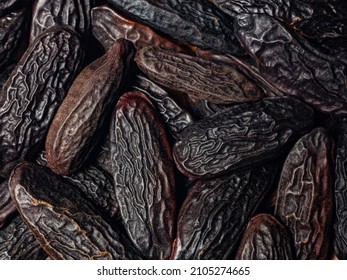 good food background from spices. macro photo of heap tonka beans in detail large root beans