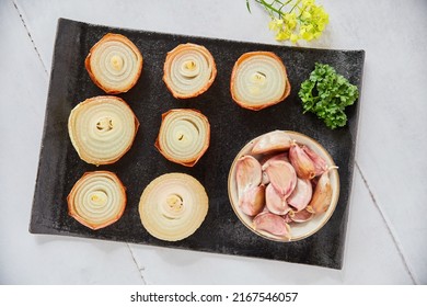 Good Food Is The Foundation Of Genuine Happiness. Overhead Shot Of Roasted Onions On A Black Serving Plate.