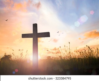 Good Friday concept: Silhouette cross of Jesus Christ on meadow autumn sunrise background - Powered by Shutterstock