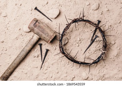 Good Friday, Passion of Jesus Christ. Crown of thorns, hammer, old nails on ground. Christian Easter holiday. Top view, copy space. Crucifixion, resurrection of Jesus Christ. Gospel, salvation.