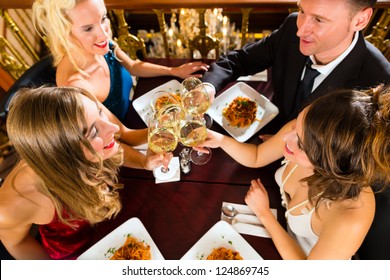 Good Friends For Dinner Or Lunch In A Fine Restaurant, Clinking Glasses