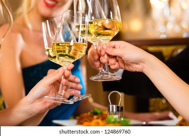 Good Friends For Dinner Or Lunch In A Fine Restaurant, Clinking Glasses