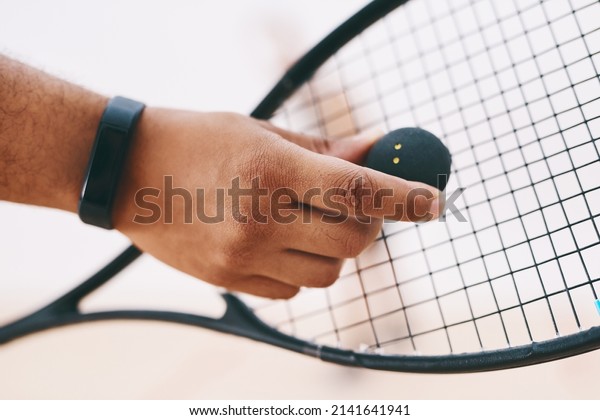 A good game\
starts with a good serve. Cropped shot of a man serving a ball with\
a racket during a game of\
squash.
