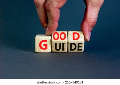 Good guide symbol. Concept words Good guide on wooden cubes. Businessman hand. Beautiful grey table grey background. Good guide and business concept. Copy space.