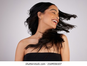 A Good Hair Day Is A Good YOU Day. Studio Shot Of A Young Woman Shaking Her Hair While Standing Against A Grey Background.