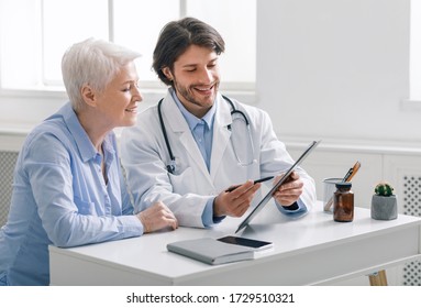 Good Health Condition. Doctor Showing Analysis Results To Senior Patient After Annual Checkup