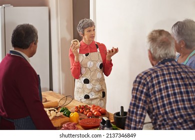 Good health is in the cooking. Shot of a woman instructing a cooking class. - Powered by Shutterstock