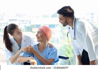 Good Hospital Provide Quality Medical Service. Professional Doctor, Nurse Take Care A Patient.  Senior Caucasian Woman Cover Head With A Cloth Caused Of Chemotherapy Cancer, Smiling Sitting Wheelchair