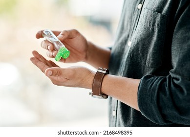 Good hygiene is in your hands. Cropped shot of a businessman using hand sanitiser to disinfect his hands. - Powered by Shutterstock