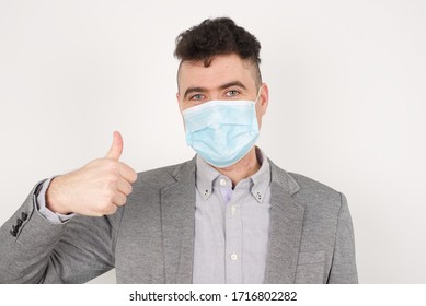 Good Job! Portrait Of A Happy Smiling Blue Eyed Young Successful Man Giving Thumb Up Gesture Standing Outdoors. Positive Human Emotion Facial Expression Body Language. 