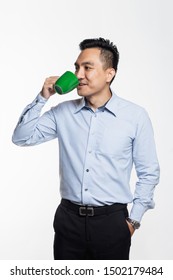 Good looking asian man holding a coffee mug