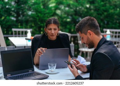 A Good Looking Businessman Is Chatting On His Phone While His Gorgeous Girlfriend Is Trying To Sneak A Look Up