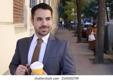 Good Looking Businessman Holding Coffee Cup To Go