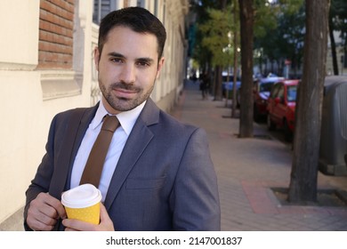 Good Looking Businessman Holding Coffee Cup To Go