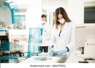 Good Looking Chemists Looking Busy While Running Blood Tests In A Clinical Laboratory