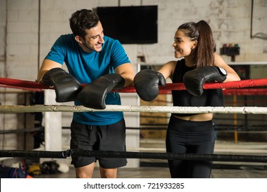 Good looking couple of boxers taking a break from training and flirting with each other in a boxing gym - Powered by Shutterstock