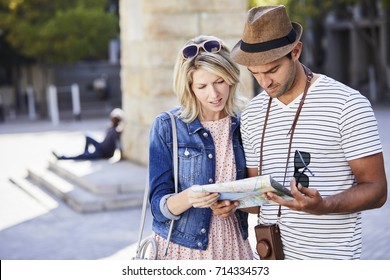 Good Looking Couple Lost In City Reading Map