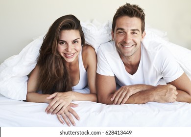 Good Looking Couple Lying In Bed, Portrait