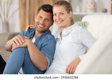 A Good Looking Couple Relaxing On Their Couch At Home