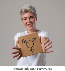 Good Looking Happy And Proud Trans Teenager Holding The Symbol Of The Transgender Drawn On A Cardboard Plate. Conceptual Image Of Gender Identity And Diversity. Human Rights And Equality Campaign.