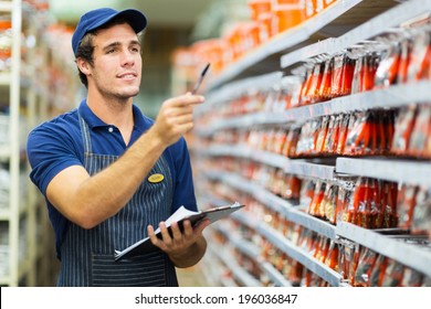 Good Looking Hardware Store Worker Counting Stock