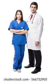 Good Looking Hispanic Young Doctor And A Cute Nurse Looking Serious On A White Background