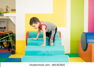 Good looking kid descending some steps in an obstacle course at a physical rehabilitation center