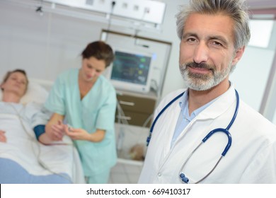 good looking latin doctor standing in a hospital room - Shutterstock ID 669410317
