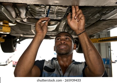 Good Looking Mechanic Checking Out Vehicle
