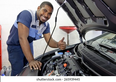 Good Looking Mechanic Giving Thumbs Up And Smiling
